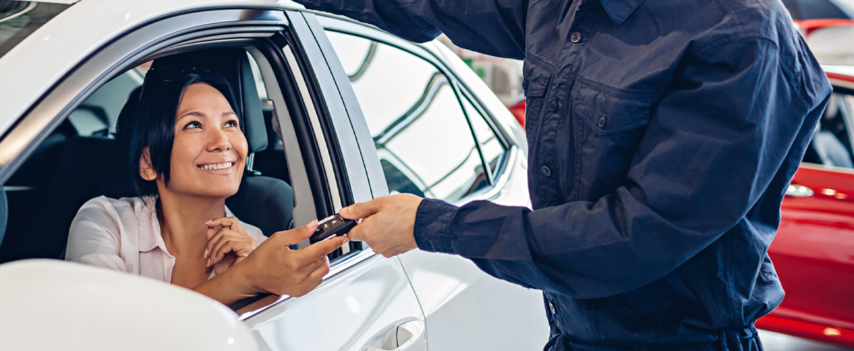 Woman receiving keys from mechanic for car | A Plus Automotive